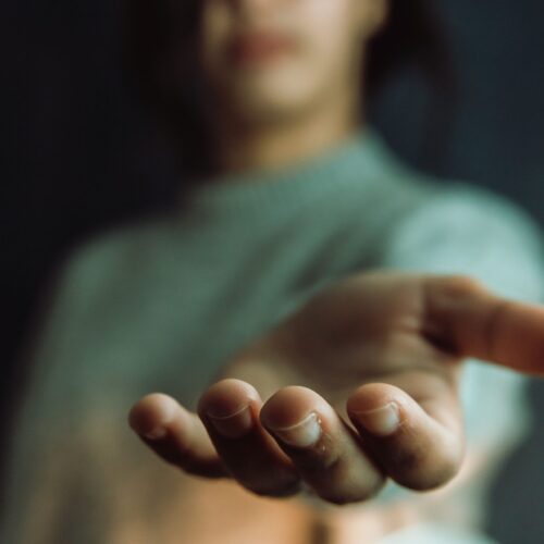Woman giving hands to the camera, help and self help concept, mental health